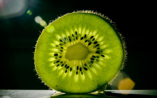 Kiwi slice flat black background - half free wallpaper
