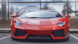 Red sports car parking lot 33 - a fence and a building free wallpaper