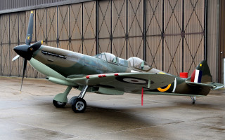 Small green airplane building open - a door open free wallpaper