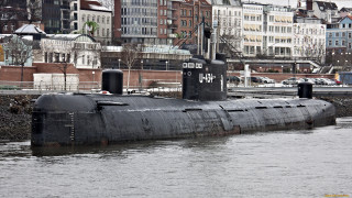 Submarine city bridge man redjacket - the water near a city free wallpaper