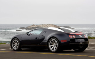 Black sports car ocean rock - luxury free wallpaper