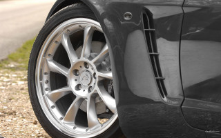 Car tire closeup roadside grass - a close up of a car tire free wallpaper
