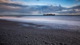 Beach rock formation ocean mountain - a cloudy sky free wallpaper