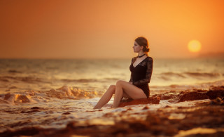 Woman rock ocean sunset sitting - artur tarnowski free wallpaper