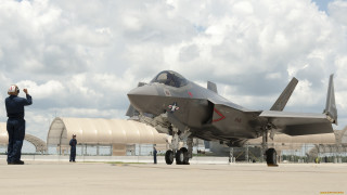 Fighterjet man suit tarmac cloudy - a man in a suit and tie free wallpaper