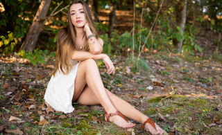 Woman forest sitting crossed legs 2 - livia prima free wallpaper