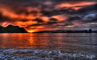 Sunset water mountain boat city - the water and a mountain in the distance free wallpaper