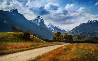 Dirt road grassy field mountains 3 - a grassy field free wallpaper