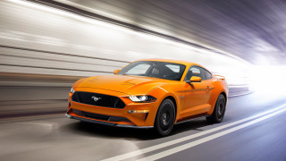 Bright orange mustang driving highspeed - a street free wallpaper for desktop