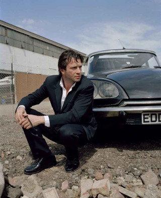 Man suit car rocky ground - david annand free wallpaper