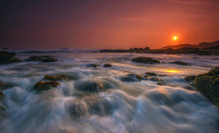 Sunset water rocks island bridge - a small island in the distance free wallpaper