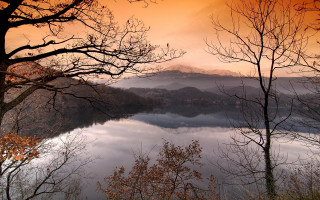Lake mountains trees sunset clouds - tree and mountains under a cloudy sky free wallpaper