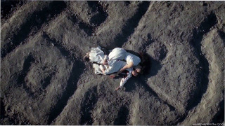 Man laying sand cellphone hands - movie still frame free wallpaper for desktop