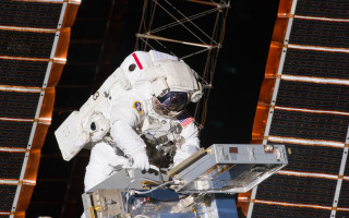 Space suit man working satellite - free space wallpaper