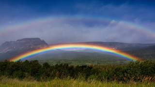 Rainbow mountain lake sky forest - over a mountain range in the distance free wallpaper