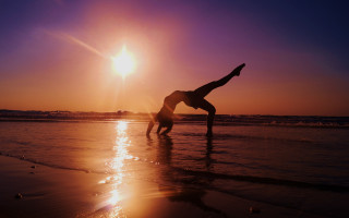 Beach sunset handstand silhouette ocean - free beach wallpaper