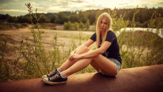 Woman sitting ledge river outdoors - a river in the background free wallpaper