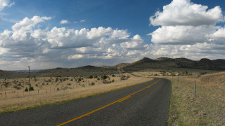 Road field mountains clouds sky - free sky wallpaper