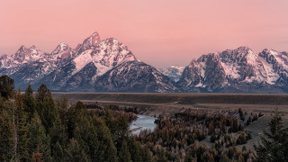 Mountain range river trees sunset - a pink sky in the background free wallpaper for desktop