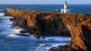 Lighthouse cliff ocean waves sunset 2 - a cliff free wallpaper