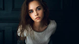 Blue eyes white shirt portrait - a black wall free wallpaper