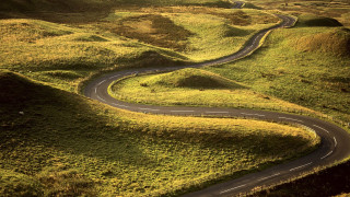 Winding road green hillside grass - road free wallpaper