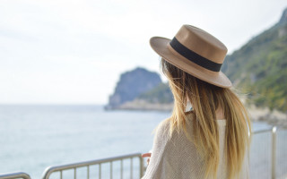 Woman hat ocean balcony cliff - a cliff side free wallpaper