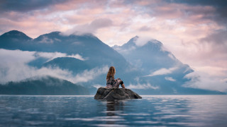 Woman rock lake mountains clouds - tranquil free wallpaper
