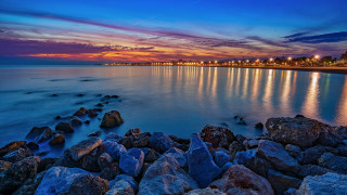 Sunset rocky beach cityscape water - rocky free wallpaper