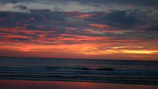 Sunset ocean surfer clouds beach - a sunset over the ocean free wallpaper