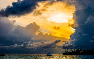 Boat water sky clouds sunset - the water under a cloudy sky free wallpaper