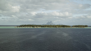 Small island houses mountain ocean - a mountain in the distance free wallpaper