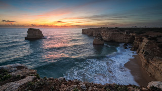 Sunset ocean cliff water beach - a sunset over the ocean free wallpaper for desktop