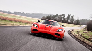 Red sports car country road - grassy free wallpaper