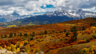 Mountain foliage sunset clouds forest - a scenic view of a mountain range free wallpaper