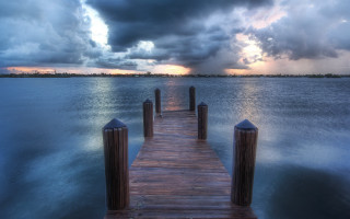 Wooden dock ocean storm clouds - the ocean under a cloudy sky free wallpaper