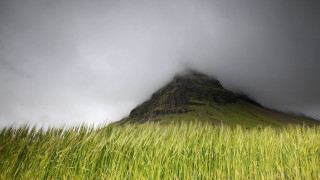Tall green mountain grass field - a dark sky above free wallpaper for desktop