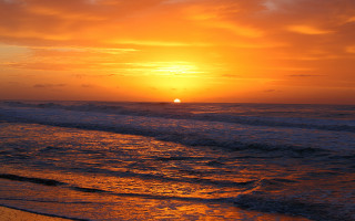 Sunset ocean waves beach surfboard 2 - a sunset over the ocean free wallpaper