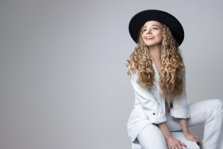 Woman blonde hat sitting blue - white pants free wallpaper for desktop