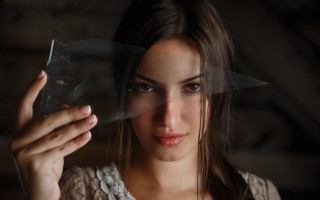 Woman holding plastic serious look - anamorphic free wallpaper for desktop