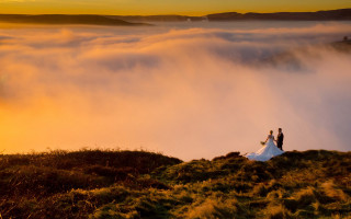 Hill clouds sunset valley city - a couple standing free wallpaper