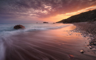 Bascove beach rock sunset clouds - a rock in the middle of it free wallpaper