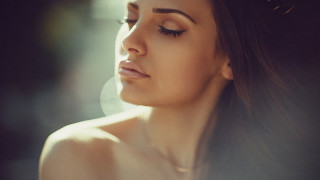 Woman longhair necklace looking down - natural free wallpaper