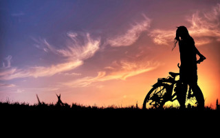 Person bike field sunset clouds - cinematic photography free wallpaper