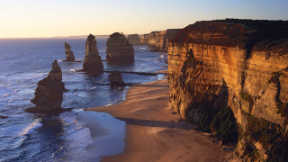Beach tall rocks people sand - a few person free wallpaper