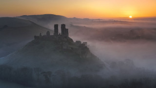 Castle foggy valley sunset clouds - the sun in the distance free wallpaper for desktop