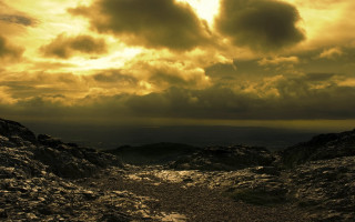 Dirt path mountain cloudy sky 3 - a sunbeam in the distance free wallpaper