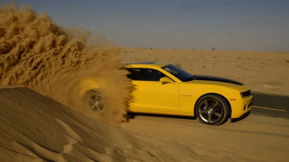 Yellow car desert sand blowing - a desert area free wallpaper