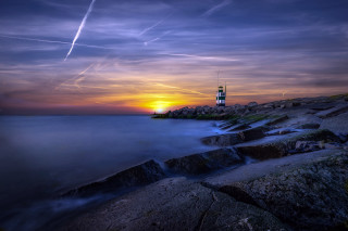 Lighthouse rocky shore sunset contrails - a lighthouse free wallpaper