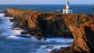 Lighthouse cliff ocean waves beach - a cliff free wallpaper